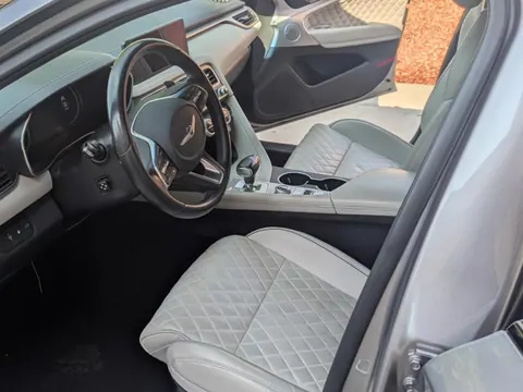 Clean light gray quilted seats and dash inside a Genesis G70