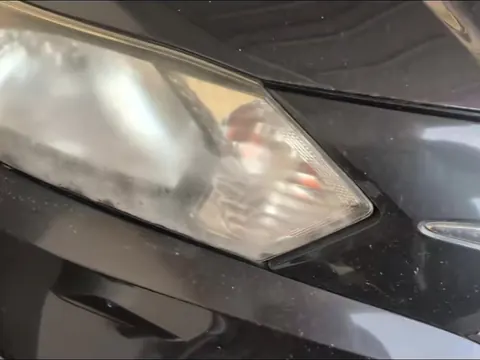 Foggy headlight on a dark gray Honda HR-V