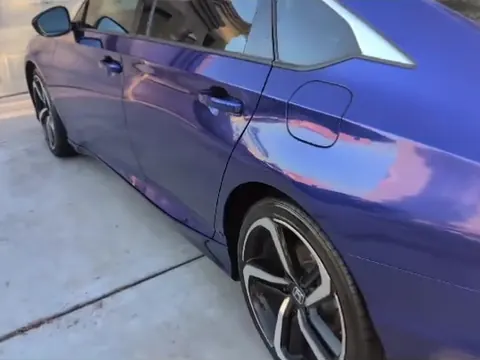Blue Honda Accord after a wash, paint shining in the driveway