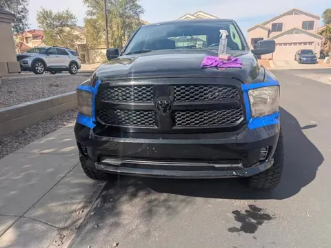 Dusty black Ram 1500 with its headlights taped off
